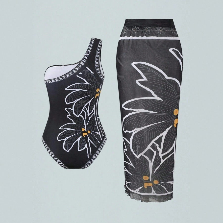 Black one-piece swimsuit and matching sarong laid flat, daisy print women swimwear collection